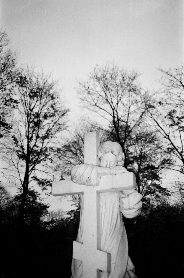 Monochrome image of an angel statue in a cemetery, Saint Petersburg.