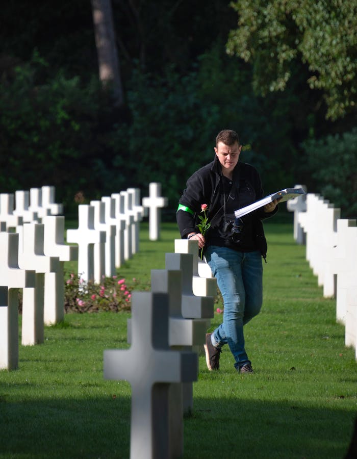 Man pays tribute to fallen soldiers at Normandy American Cemetery in France.